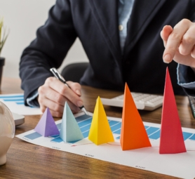front-view-businessman-with-colorful-cones-representing-growth
