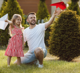 happy-father-playing-with-daughter-planes-outdoor