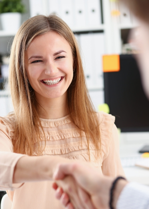 Businessman and woman shake hands as hello in office closeup. Friend welcome introduction greet or thanks gesture product advertisement partnership approval arm strike a bargain on deal concept